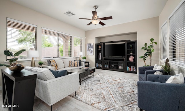 living room featuring ceiling fan and light hardwood / wood-style floors