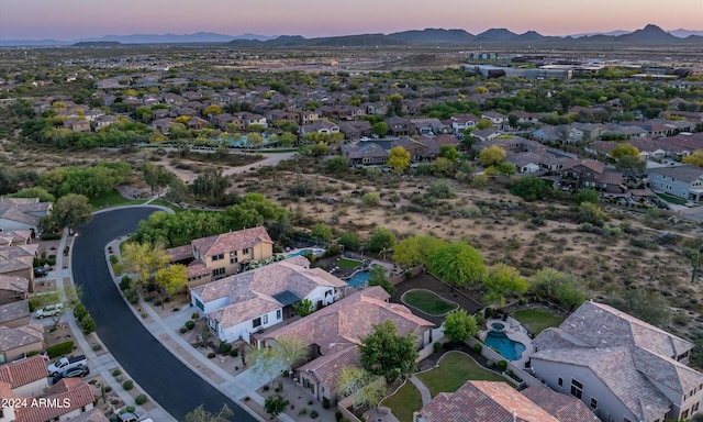 aerial view at dusk featuring a mountain view