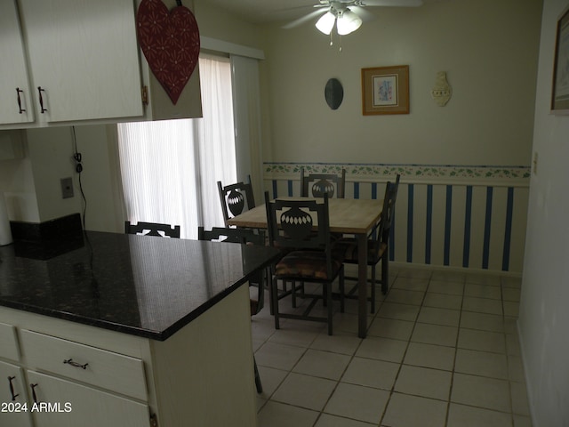 dining area with ceiling fan, a healthy amount of sunlight, and light tile floors