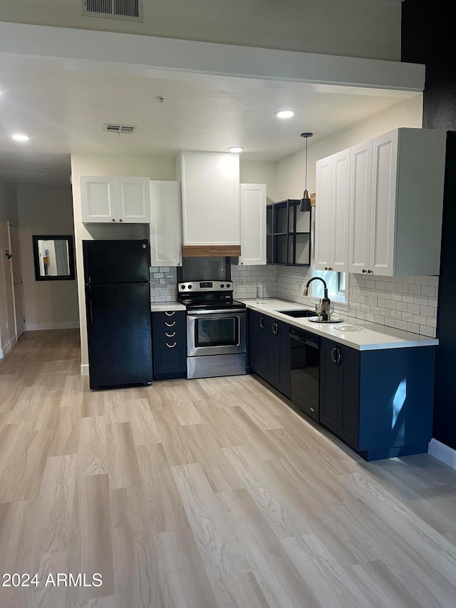 kitchen featuring sink, black appliances, white cabinets, and decorative light fixtures