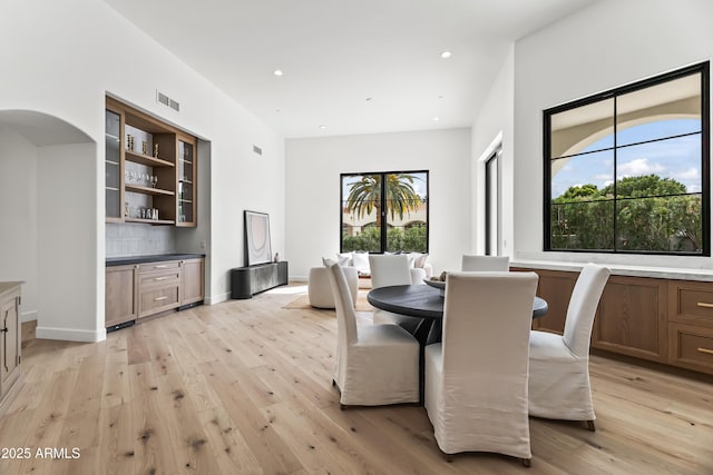 dining space with recessed lighting, baseboards, and light wood-style floors