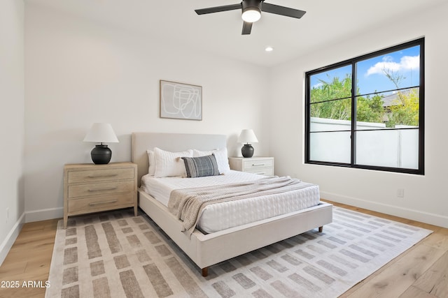 bedroom with recessed lighting, light wood-type flooring, and baseboards