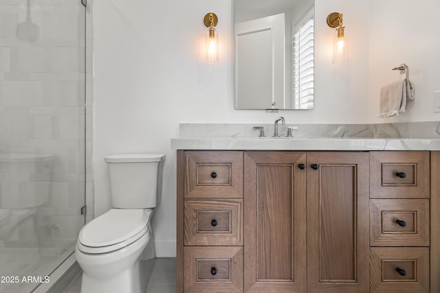 full bath with vanity, a shower stall, and toilet