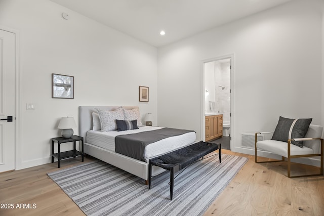 bedroom with visible vents, light wood-style flooring, ensuite bathroom, recessed lighting, and baseboards