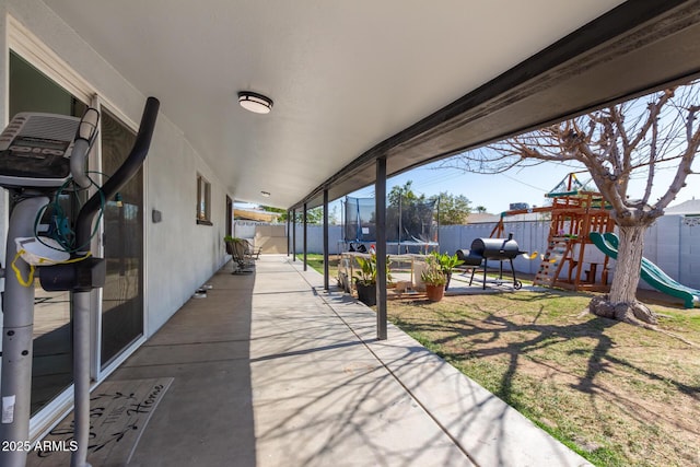 view of patio / terrace featuring a trampoline, area for grilling, and a playground