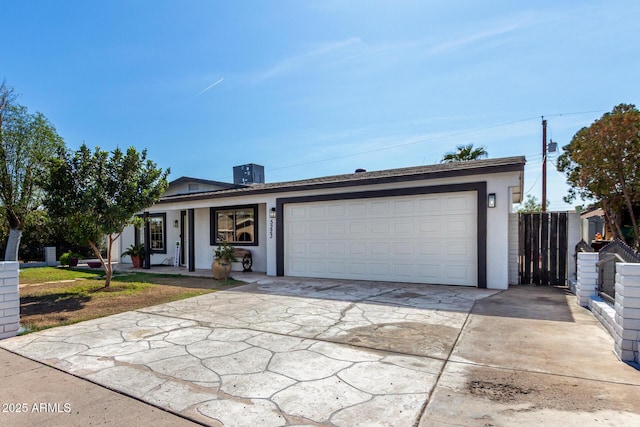 single story home featuring a garage and a front lawn