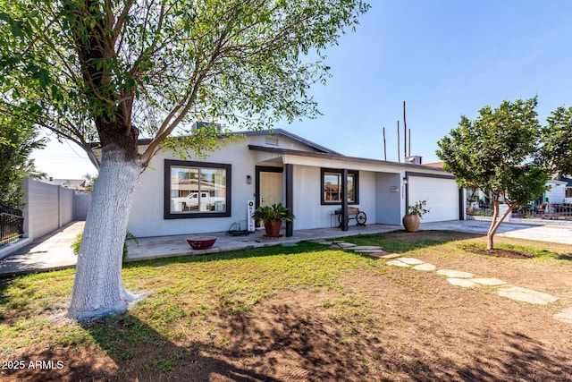 view of front of house with a front yard and a garage