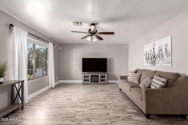 living room with light wood-type flooring and ceiling fan