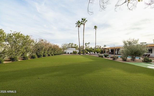 view of property's community featuring a swimming pool and a lawn