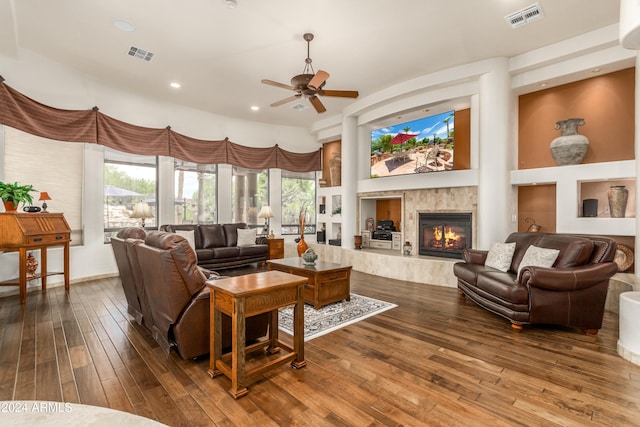 living room with hardwood / wood-style floors, ceiling fan, and a fireplace