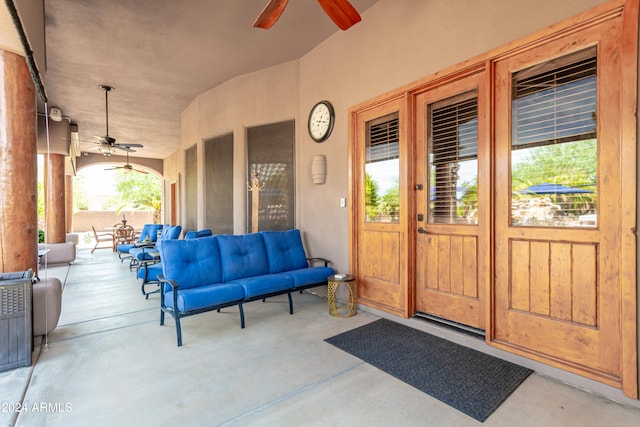 entrance to property featuring a patio, outdoor lounge area, and ceiling fan