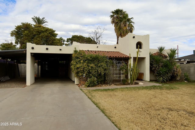 adobe home with a front yard and a carport