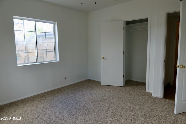 unfurnished bedroom with a closet and light carpet