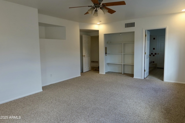 unfurnished bedroom featuring ceiling fan, ensuite bath, a closet, and light carpet