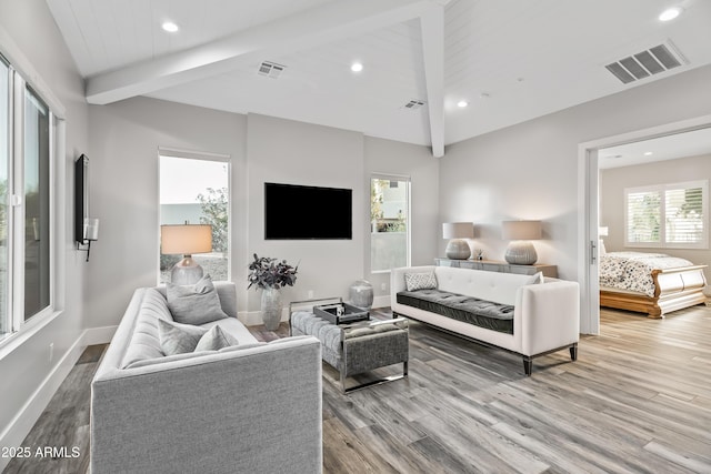 bedroom featuring hardwood / wood-style floors and lofted ceiling with beams