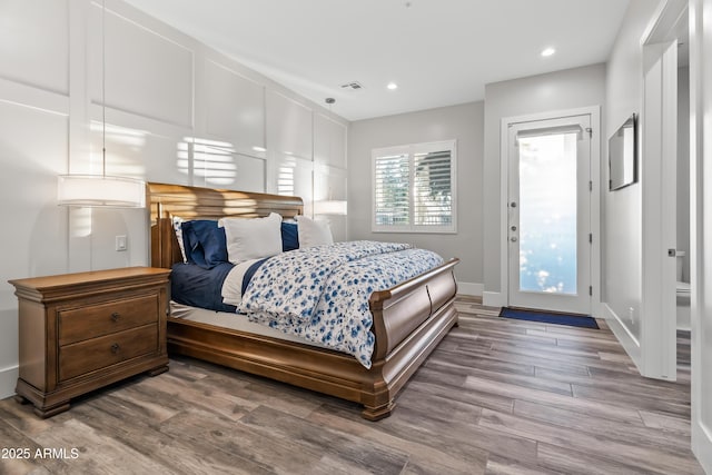 bedroom featuring hardwood / wood-style flooring and access to outside