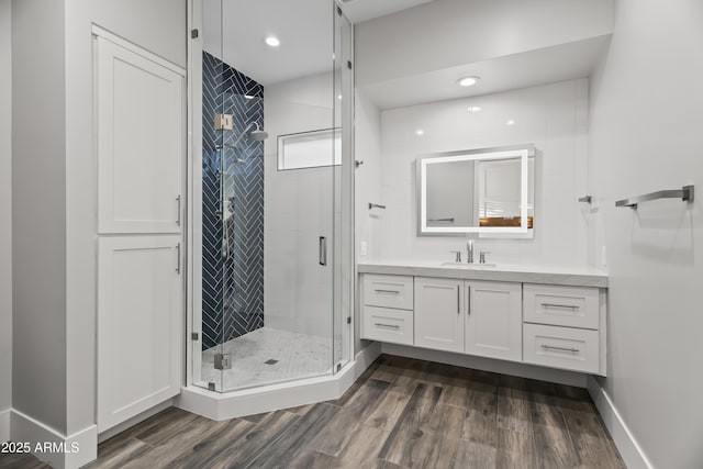 bathroom featuring vanity, hardwood / wood-style floors, and an enclosed shower