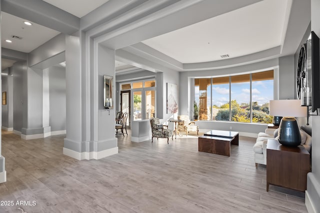 living room with a wealth of natural light and light hardwood / wood-style floors