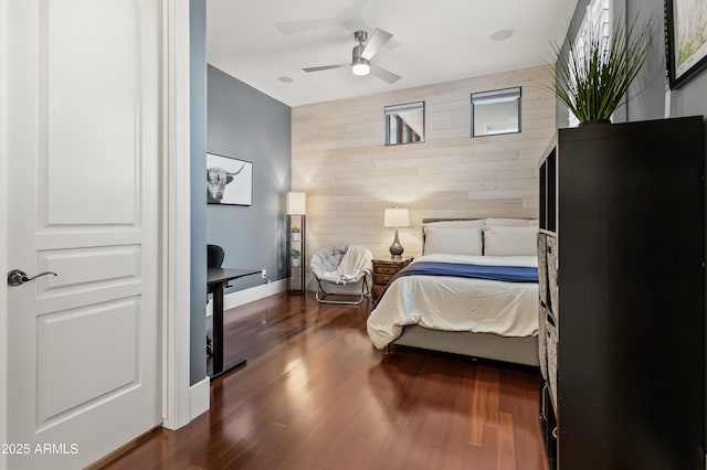 bedroom featuring dark hardwood / wood-style flooring and wood walls