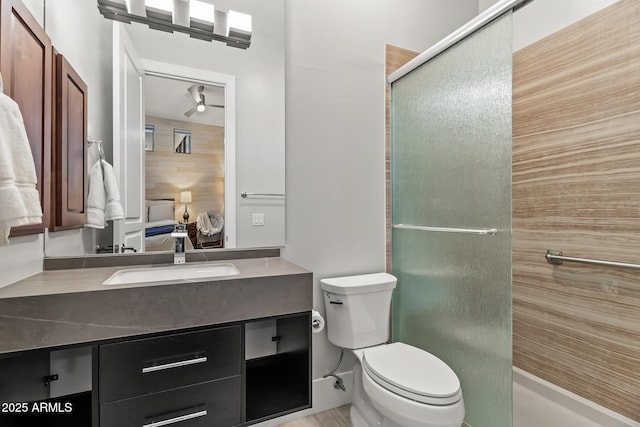 bathroom featuring vanity, an enclosed shower, and toilet