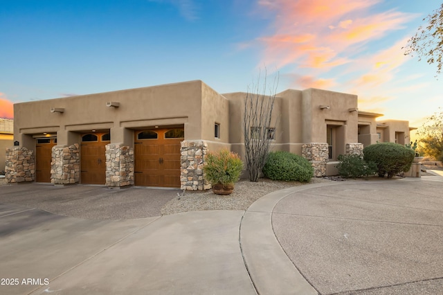 pueblo-style home featuring a garage