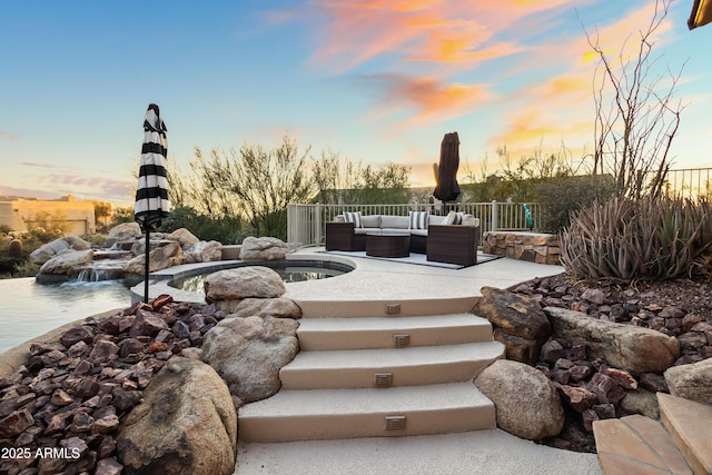 view of community featuring an outdoor living space and a patio