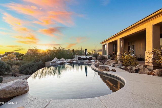 view of pool at dusk