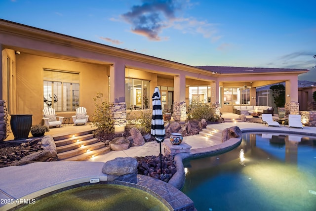 exterior space featuring a pool with hot tub and a patio area