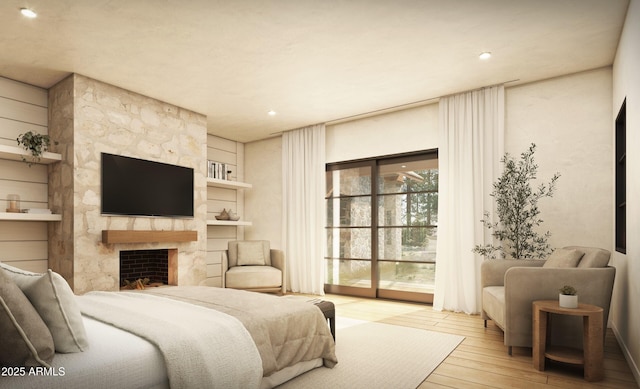 bedroom featuring a large fireplace, recessed lighting, wood-type flooring, and access to exterior