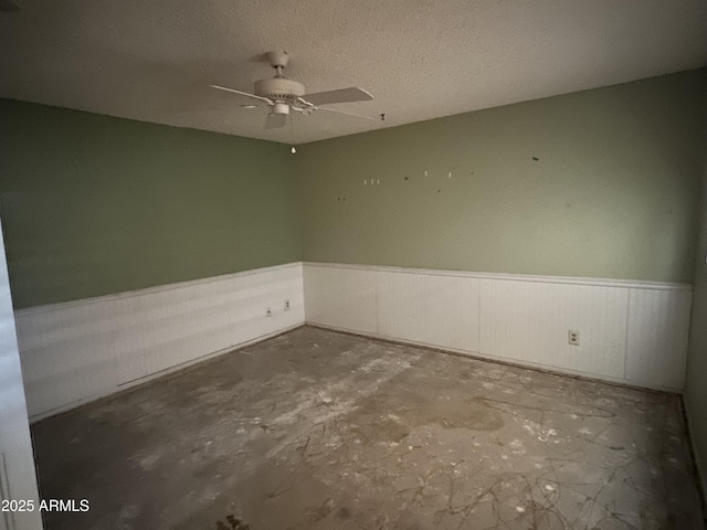 8063 N 31st Ln, Phoenix, AZ 85051 - unfurnished room with a wainscoted wall and a ceiling fan