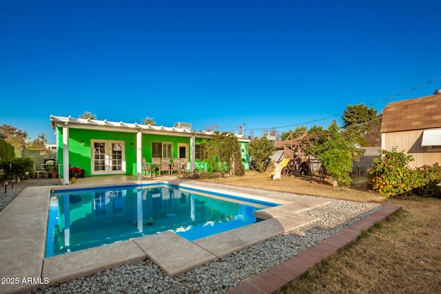 view of pool with french doors