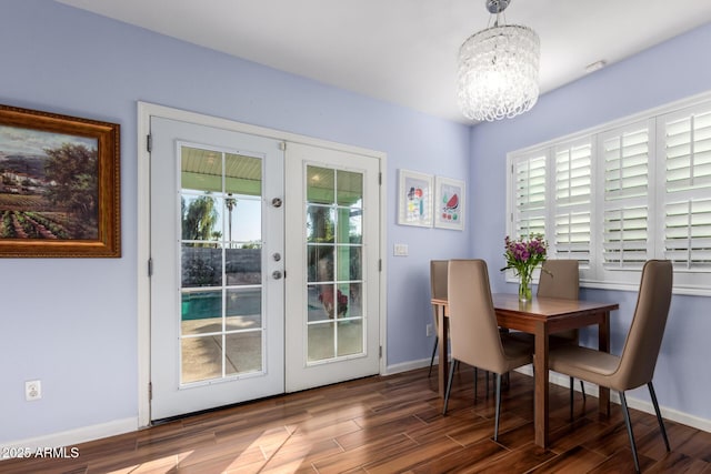 dining room with a notable chandelier and french doors