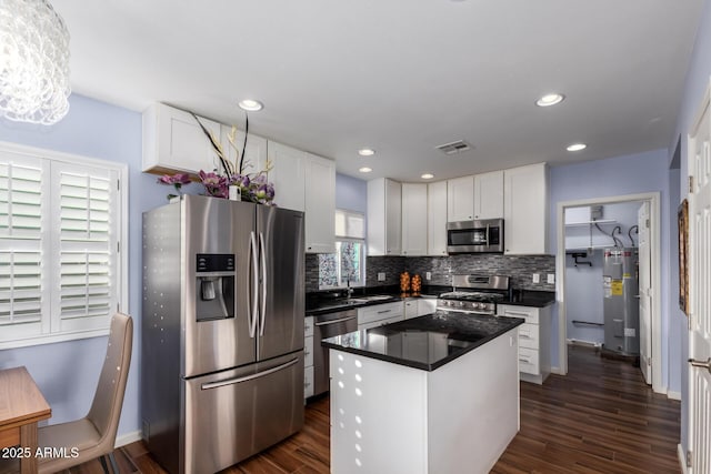 kitchen with a center island, white cabinets, dark hardwood / wood-style floors, and appliances with stainless steel finishes