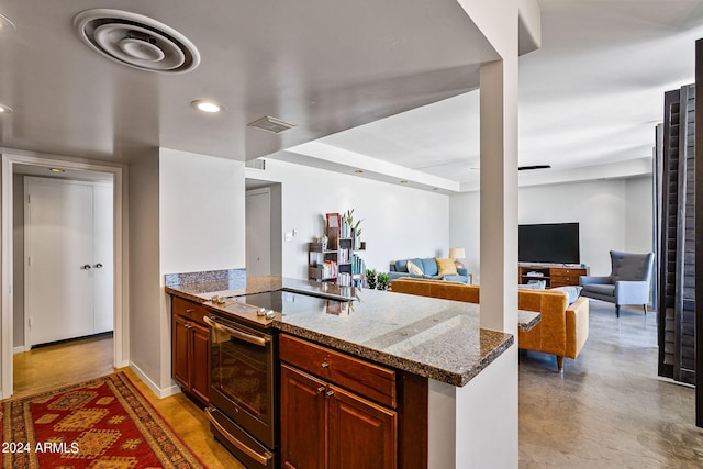 kitchen with stone countertops, kitchen peninsula, and stainless steel electric range