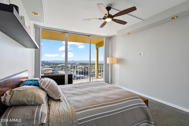 207 W Clarendon Ave Unit 20B, Phoenix, AZ 85013 - bedroom featuring expansive windows, concrete floors, baseboards, and a ceiling fan