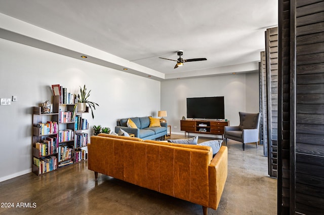 living room featuring concrete flooring and ceiling fan