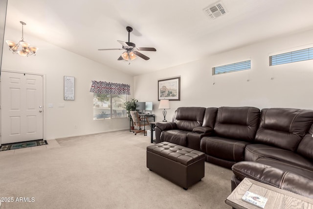 carpeted living room featuring ceiling fan with notable chandelier and lofted ceiling