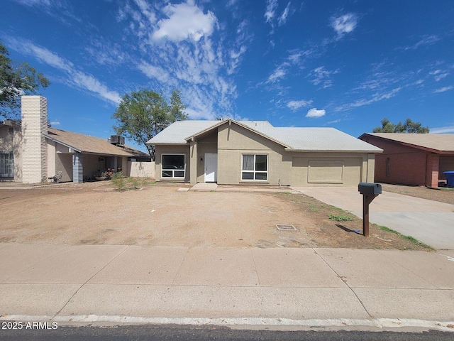 view of front of home with driveway and stucco siding