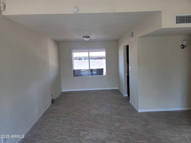 empty room featuring visible vents and baseboards