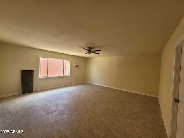 unfurnished room with baseboards and a ceiling fan