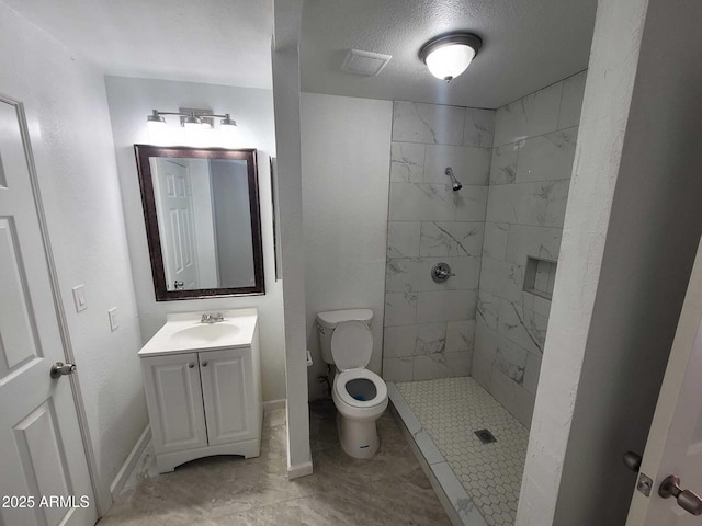 bathroom with visible vents, toilet, a textured ceiling, vanity, and a shower stall