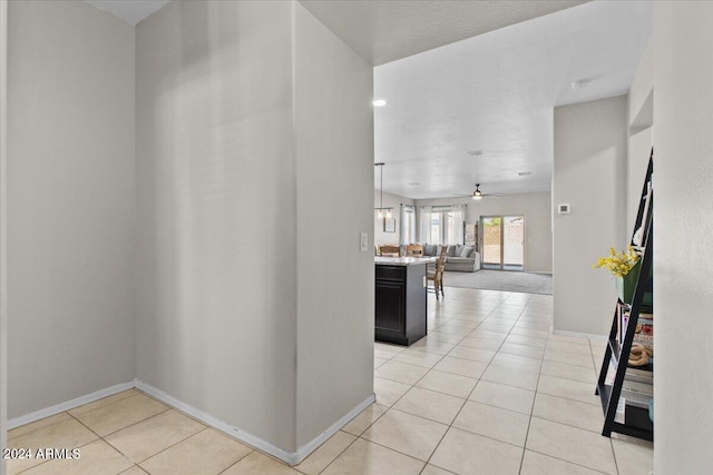 hall with light tile patterned floors