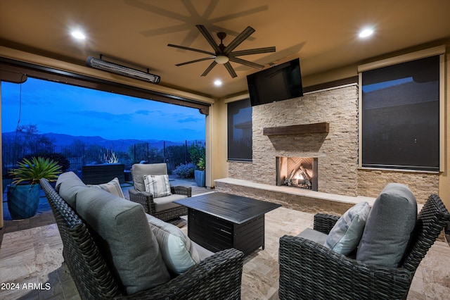 view of patio / terrace featuring an outdoor living space with a fireplace and ceiling fan