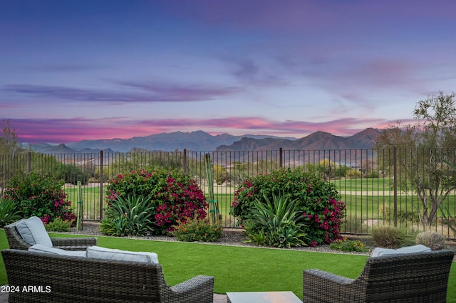 yard at dusk featuring a mountain view