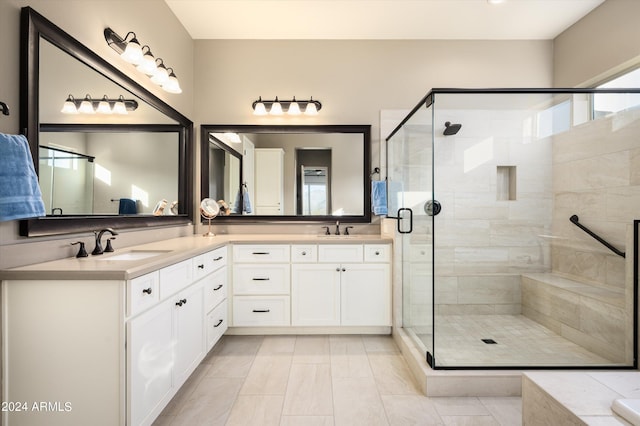 bathroom featuring vanity and a shower with shower door