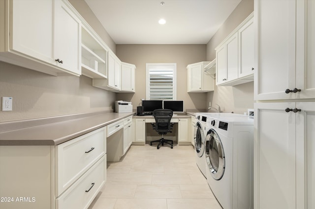 laundry room with washer and clothes dryer and cabinets