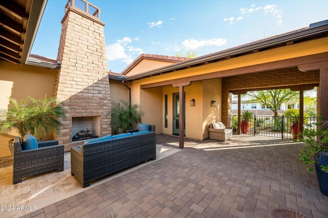 view of patio featuring an outdoor living space with a fireplace