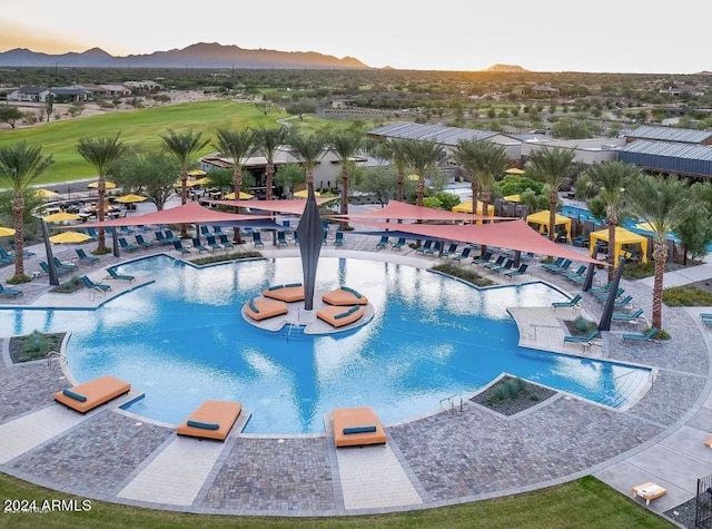 view of pool at dusk