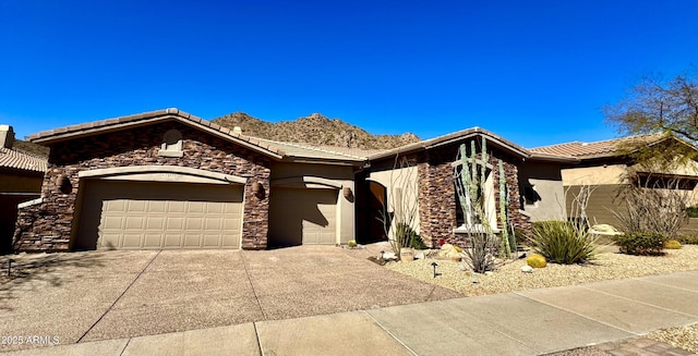 ranch-style home with a garage, stone siding, a tile roof, and stucco siding