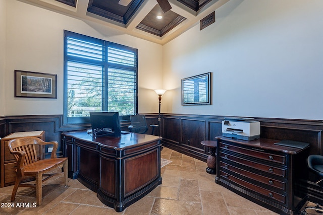 office space featuring coffered ceiling, ornamental molding, a towering ceiling, beamed ceiling, and ceiling fan